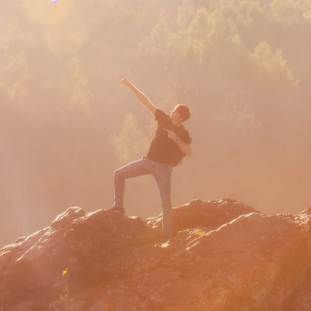 A student posing at the top of a mountain in Prague